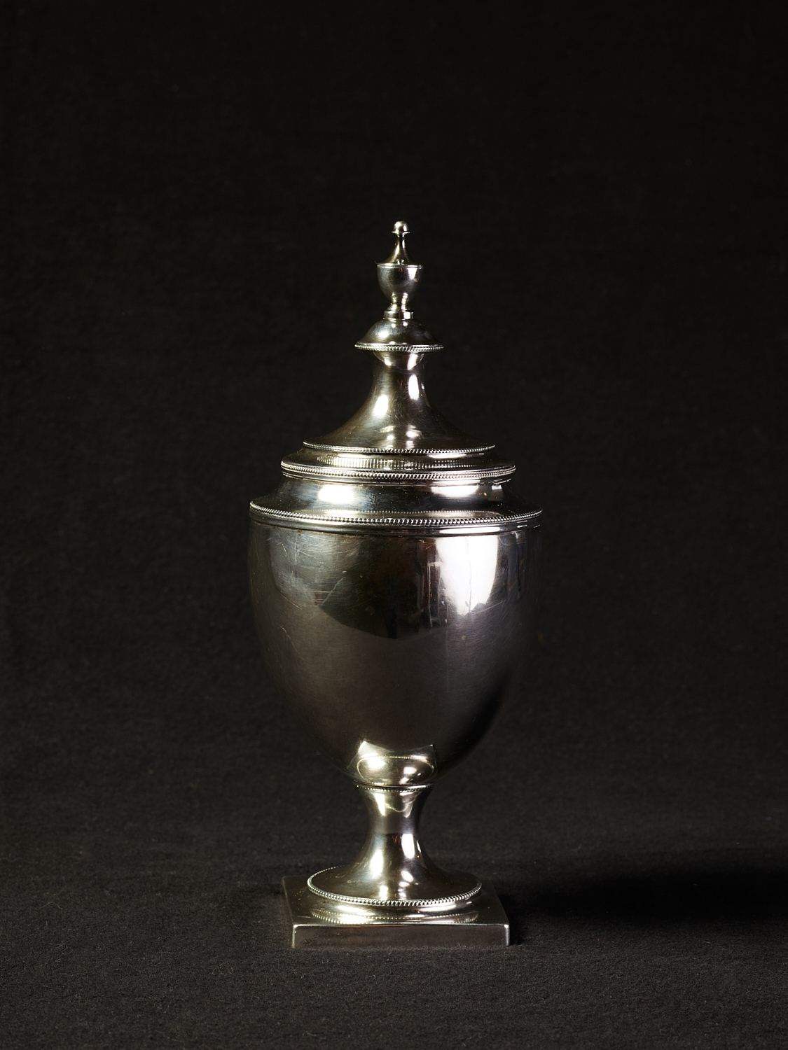 St. Louis Silver Co. cylindrical sugar bowl with two handles and a lid used  by by the Jesuits at the Saint Stanislaus Seminary in Florissant, Missouri.  Title: St. Louis Silver Co. Sugar